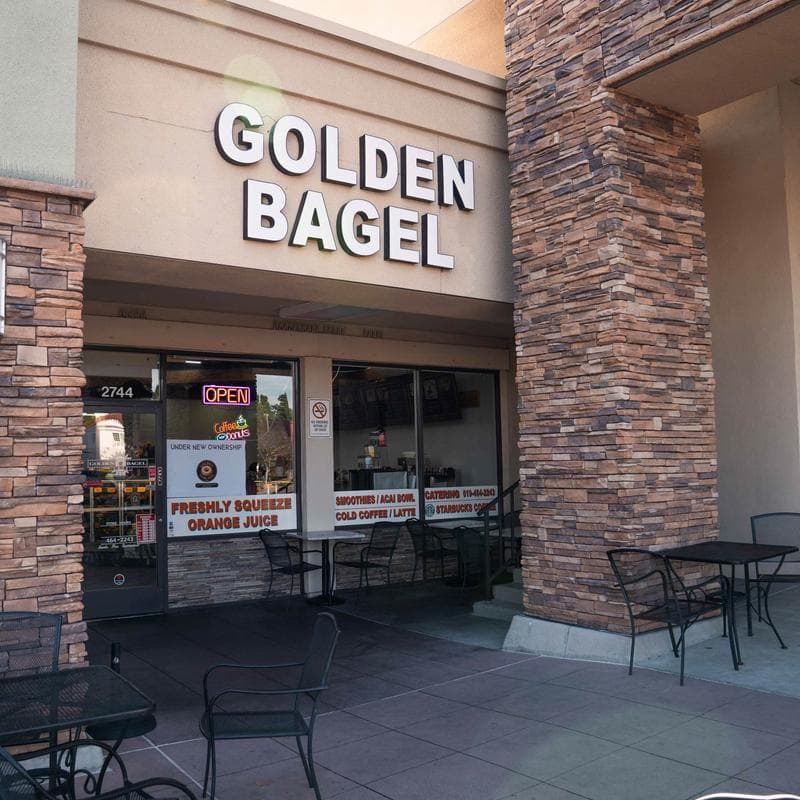 Golden Bagel exterior with outdoor seating.