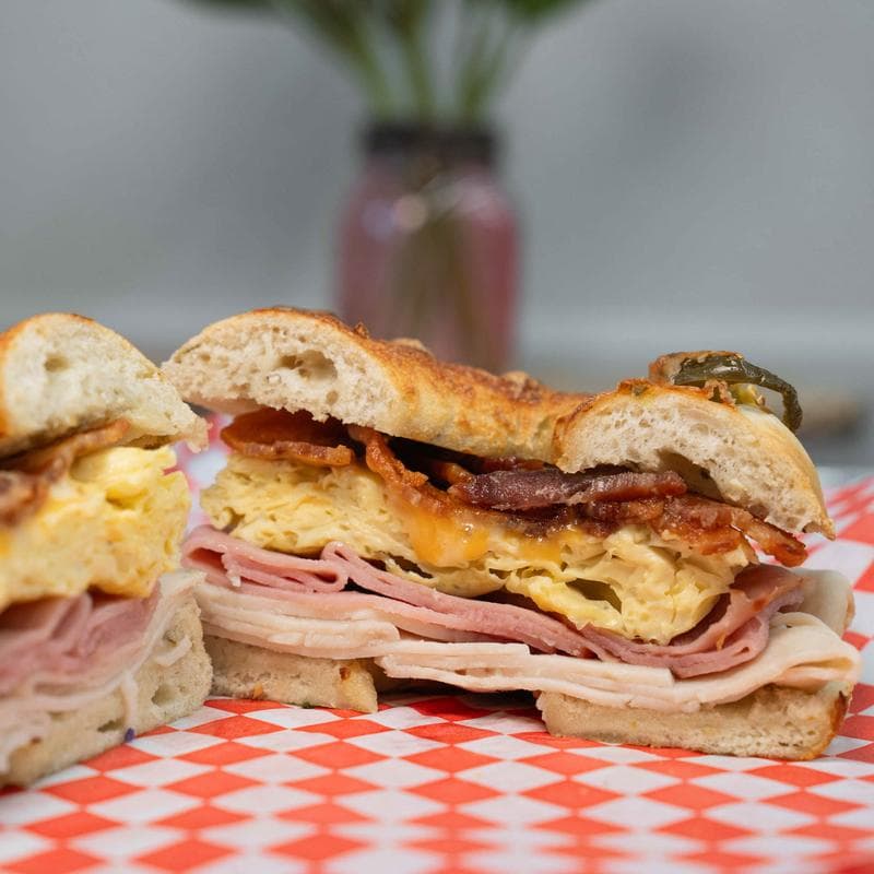 Jalapeno bagel with scrambled eggs, bacon, and deli meats.
